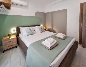 a bedroom with a bed with two towels on it at Coastal Ierapetra 1 in Ierapetra