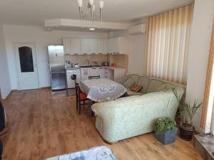 a living room with a couch and a table at Атес in Kavarna