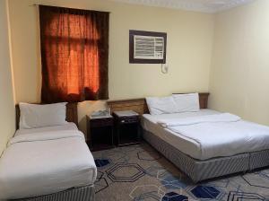 Ένα ή περισσότερα κρεβάτια σε δωμάτιο στο Saba Furnished Apartments