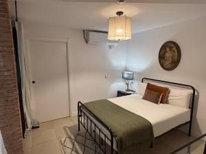 a bedroom with a bed and a clock on the wall at Santa Rita Rita B&Boutique in Talavera de la Reina