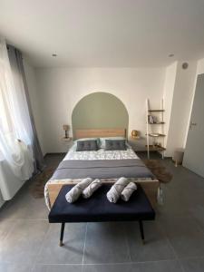 a bedroom with a large bed with pillows on it at Place du bonheur bel appartement f2 in Sarrebourg