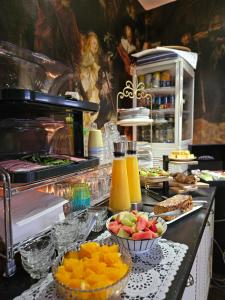 a buffet with fruits and other food on a counter at Sea Breeze apartment Hellevoetsluis in Hellevoetsluis