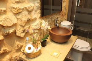 a bathroom with a copper sink and a toilet at Ananda Beach Rooms - Castillo de Peñiscola in Peniscola +94 photos