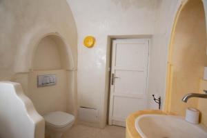 a bathroom with a toilet and a tub and a sink at Dar Nejma - Djerba Houch in Erriadh +10 photos
