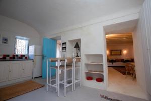 a kitchen with a white refrigerator and a counter at Dar Nejma - Djerba Houch in Erriadh