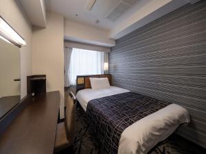Postel nebo postele na pokoji v ubytování APA Hotel Higashi Shinjuku Ekimae