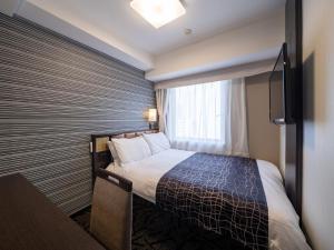 Postel nebo postele na pokoji v ubytování APA Hotel Higashi Shinjuku Ekimae