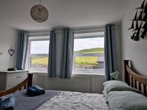 En eller flere senge i et værelse på Old Bakery Cottage