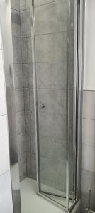 a shower with a glass door in a bathroom at Maison Belle in Sottomarina +22 photos