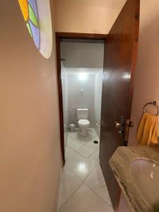 a bathroom with a sink and a toilet at Casa em Guaratinguetá-Casa da Rosa in Guaratinguetá +15 photos