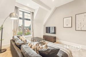 a living room with a couch and a table at The Sovereign Suite - 2-bedroom Luxury Apartment with Parking in Henley on Thames