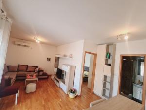 a living room with a couch and a table at Apartman Natalia in Podgorica