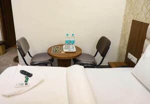 a room with chairs and a table with water bottles on it at Hotel PNP Royal in Amarnāth