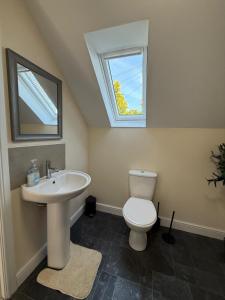 a bathroom with a sink and a toilet and a window at Rural retreat in Longframlington +8 photos