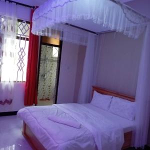 Postel nebo postele na pokoji v ubytování Sweetland view hotel