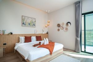 a bedroom with a large white bed and a window at The Woofington Pet Friendly Pool Villa in Ban Bo Prakhon +24 photos