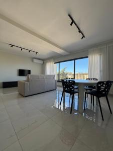 a living room with a table and chairs and a couch at The Collective in Is-Swieqi