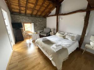 a bedroom with a bed and a living room at El Encanto de Bustares in Bustares