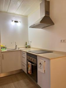a kitchen with a sink and a stove top oven at Apartment in Alfama for Two in Lisbon +5 photos