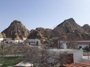 a view of the mountains from the roof of a building at Cueva Abuelo Juan in Guadix