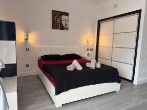 a bedroom with a large bed with pink pillows at Paraiso Sur & Panoramic Views Apartment, Tenerife in Adeje +32 photos