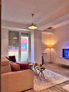 a living room with a couch and a table at Mor Maison Skopje City-Center FEW FREE PRIVATE PARKING in Skopje +69 photos