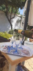 a bottle of wine is being poured into glasses on a table at Villa Allori, via degli allori in San Pietro in Bevagna in San Pietro in Bevagna