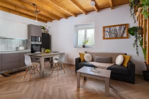 a living room with a couch and a table at Kostas Nest in Ialyssos