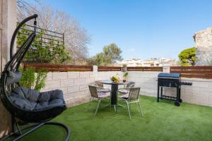 a patio with a table and chairs and a grill at Kostas Nest in Ialysos +5 photos