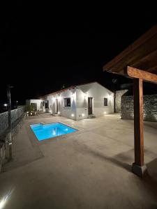 a backyard at night with a swimming pool at Natura Luxury in Las Lagunetas