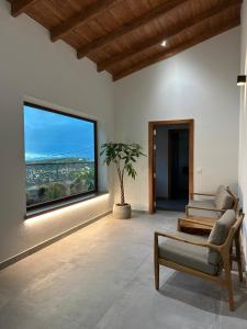 a living room with a chair and a large window at Natura Luxury in Las Lagunetas +24 photos