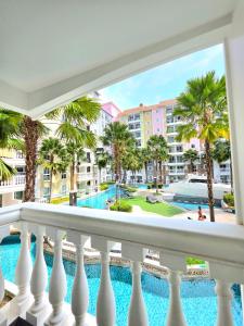 a view of the pool from the balcony of a resort at Seven Seas Cote D'azur Resort Jomtien in Na Jomtien