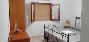 a bedroom with a bed and a window and a table at Villa Allori, via degli allori in San Pietro in Bevagna in San Pietro in Bevagna +30 photos
