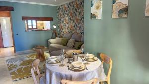 a living room with a table and a couch at Desert Springs award-winning Golf Resort apartment in La Hoya del Camaino