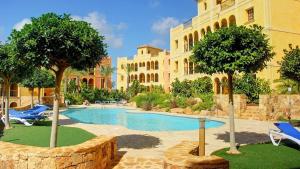 a resort with a swimming pool in front of a building at Desert Springs award-winning Golf Resort apartment in La Hoya del Camaino