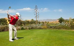 a man swinging a golf club on a green at Desert Springs award-winning Golf Resort apartment in La Hoya del Camaino