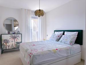 a bedroom with a large bed with a large window at Appartement Alchimy in Antibes