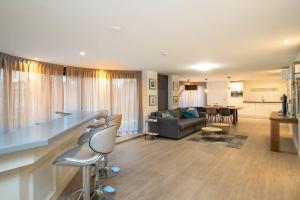 a living room with a couch and a table and chairs at Luxury apartment in the center in Medemblik