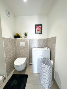 a bathroom with a white toilet and a sink at Appartement Alchimy in Antibes +18 photos