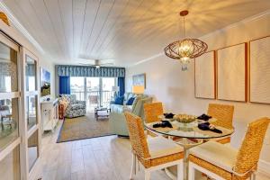 a dining room and living room with a table and chairs at Land's End 5-203 Gulf-Bay Front - Premier in St Pete Beach