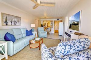 a living room with a couch and a table at Land's End 5-203 Gulf-Bay Front - Premier in St Pete Beach