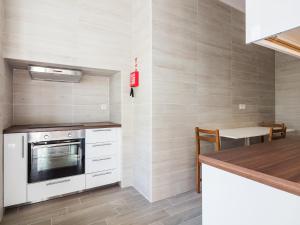a kitchen with a stove and a counter top at Vila Garden Guesthouse in Lisbon +34 photos