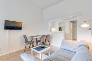 a living room with a couch and a table at Alte Teestube 55 in Norderney