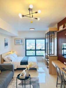 a bedroom with a bed and a living room at J Tower Residences in Mandaue City