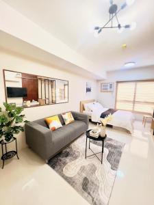 a living room with a couch and a table at J Tower Residences in Mandaue City +20 photos