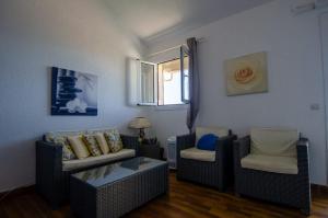 a living room with two couches and a window at Duplex 2 chambres, vue mer & balcon - 6 couchages in Porticcio +9 photos