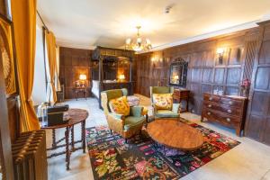 a living room with a table and chairs at Weston Manor Hotel in Bicester