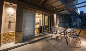 a patio with a table and chairs on a balcony at St Paul 25 Urban Apts in Kos Town