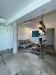 a living room with a couch and a table at Sous les pins in Sanary-sur-Mer