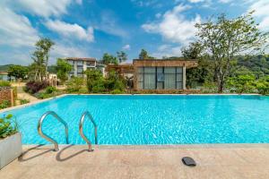 an image of a swimming pool in front of a house at Yingde YeDuGu Resort in Gaozhoupu